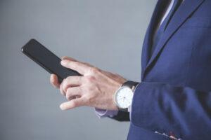 Man in suit holding smartphone